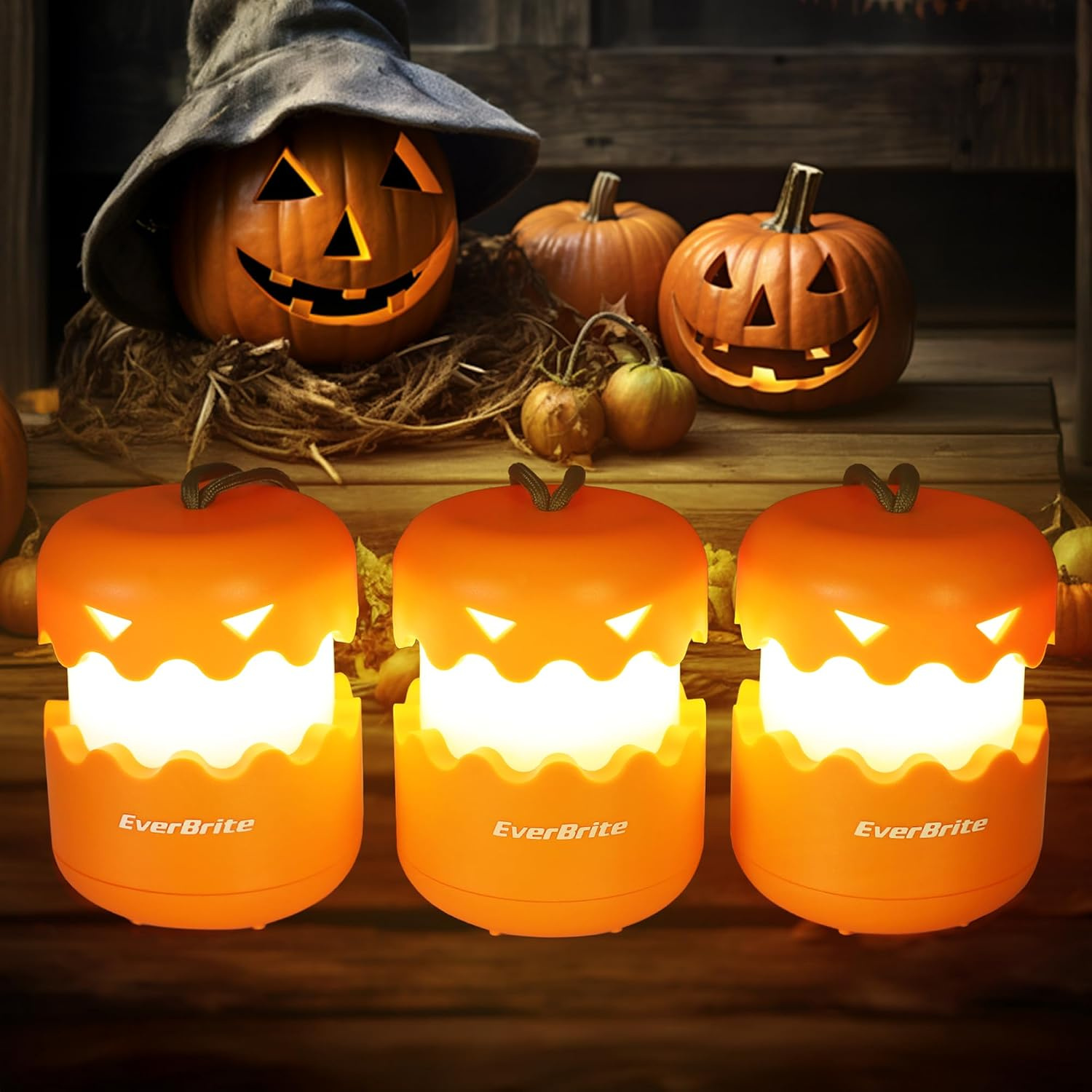 Three battery-powered orange pumpkin lantern lights with carry lanyards