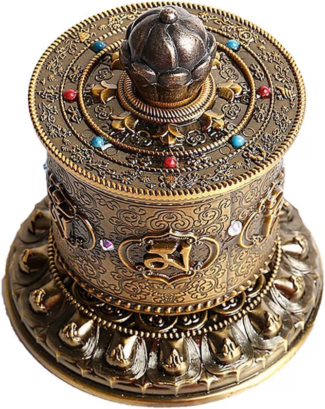 Ornate brass Tibetan prayer wheel with engraved script, a lotus finial, and a beaded lotus-petal base