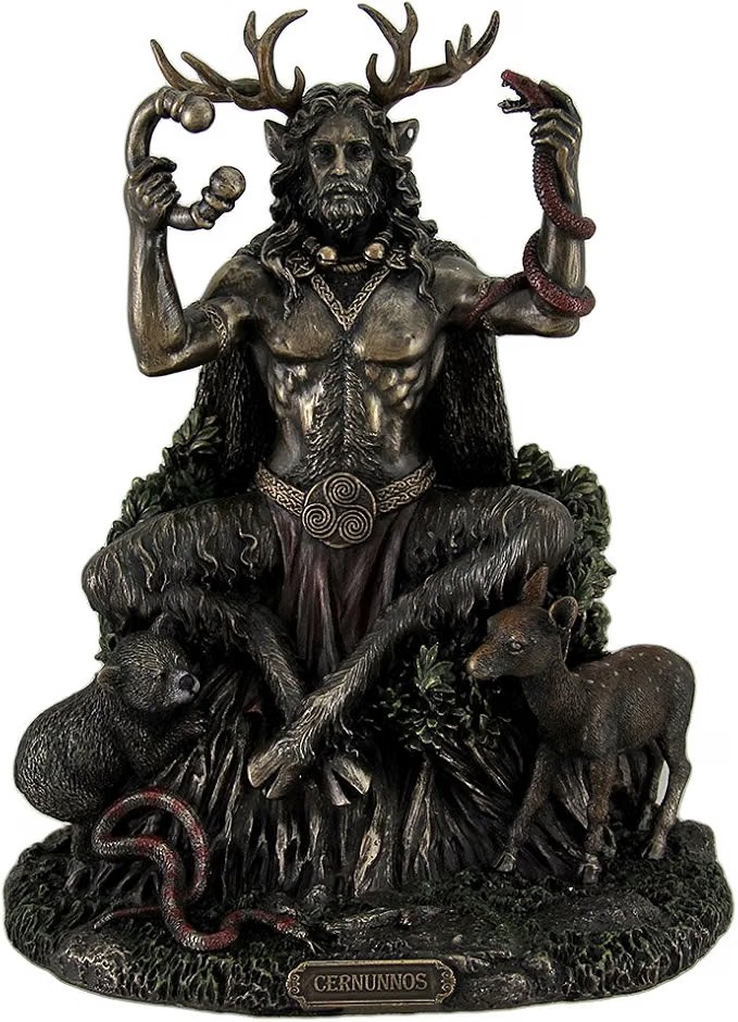 Bronze-finish statue of Cernunnos, the antlered Celtic horned god, seated cross-legged holding a torc and a serpent, with a boar and a deer at his feet