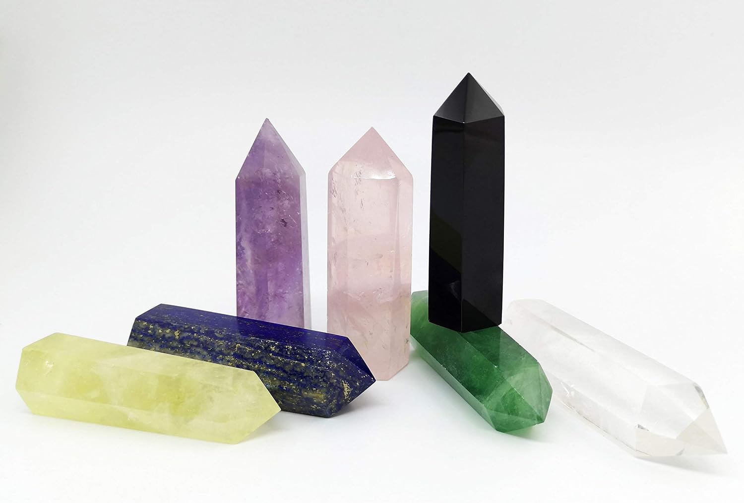 Seven-piece crystal point set — amethyst, rose quartz, black obsidian, lemon quartz, lapis lazuli, green fluorite, and clear quartz