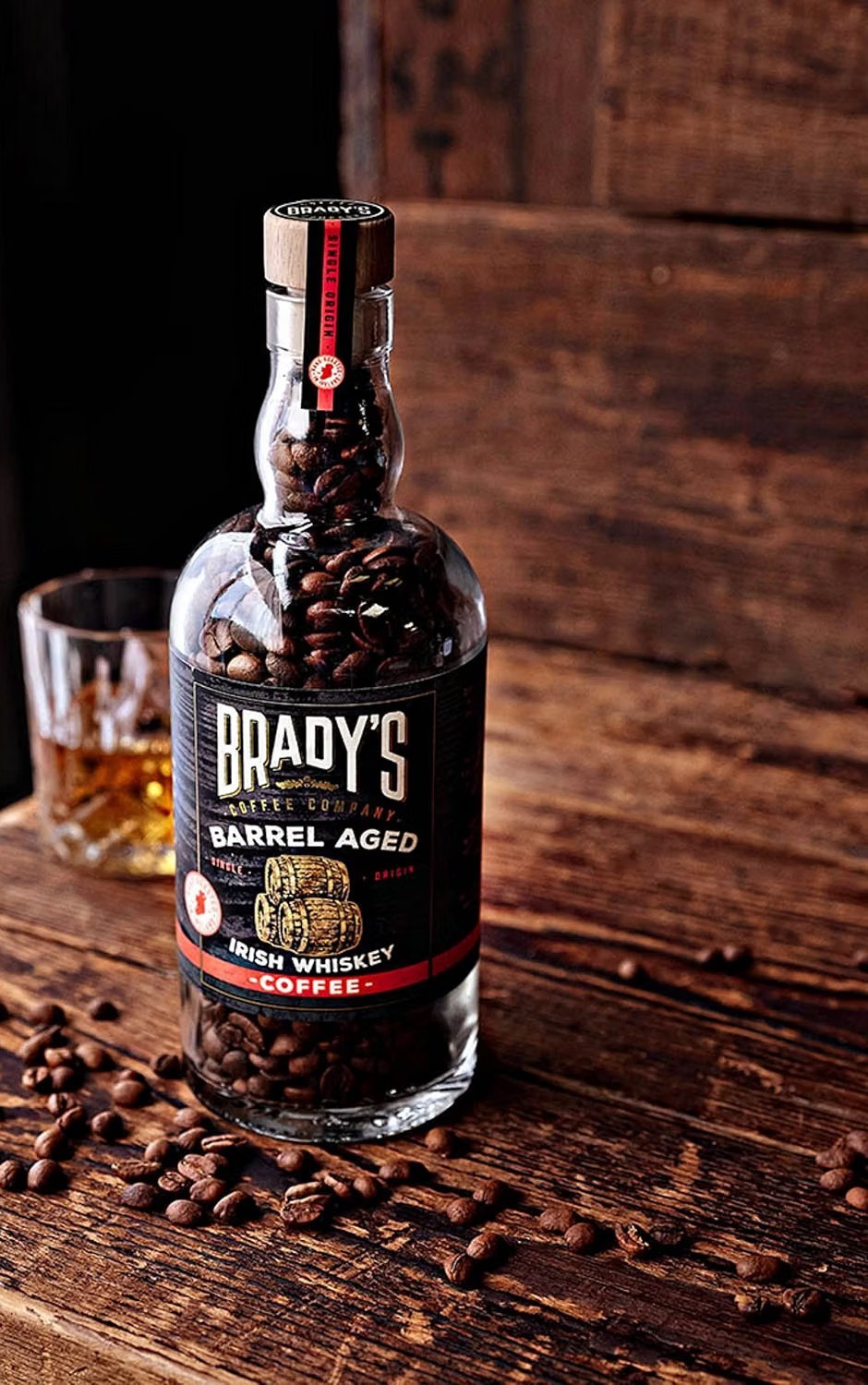 Brady's Coffee Company Irish Whiskey Barrel Aged coffee beans in a glass bottle