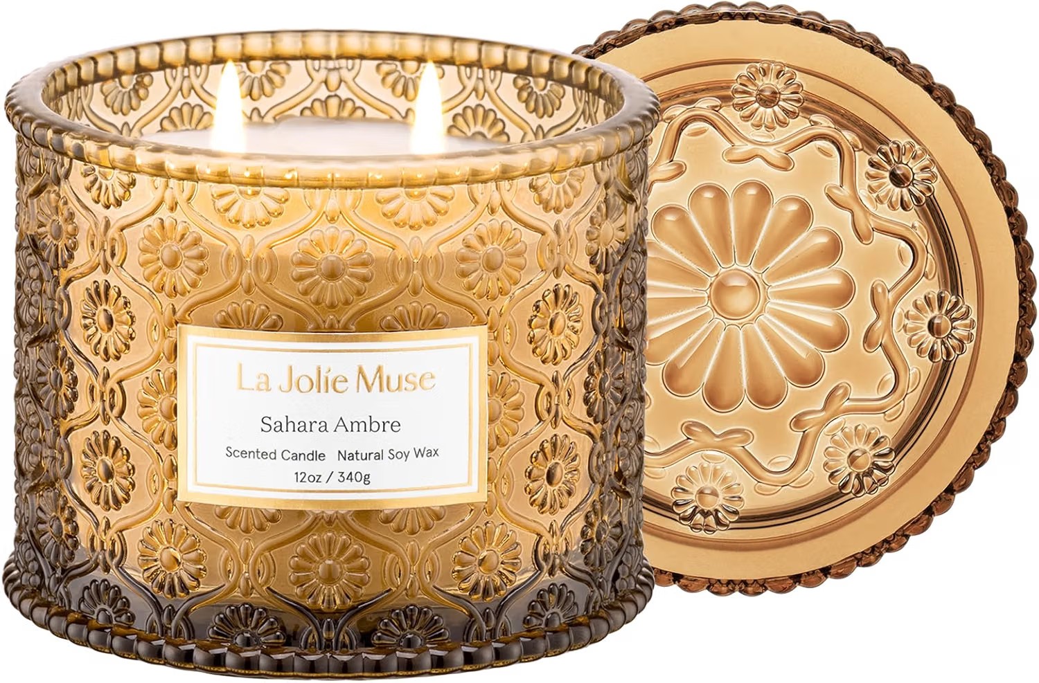 La Jolie Muse Sahara Ambre scented candle in an embossed amber glass jar with a Moroccan floral relief pattern