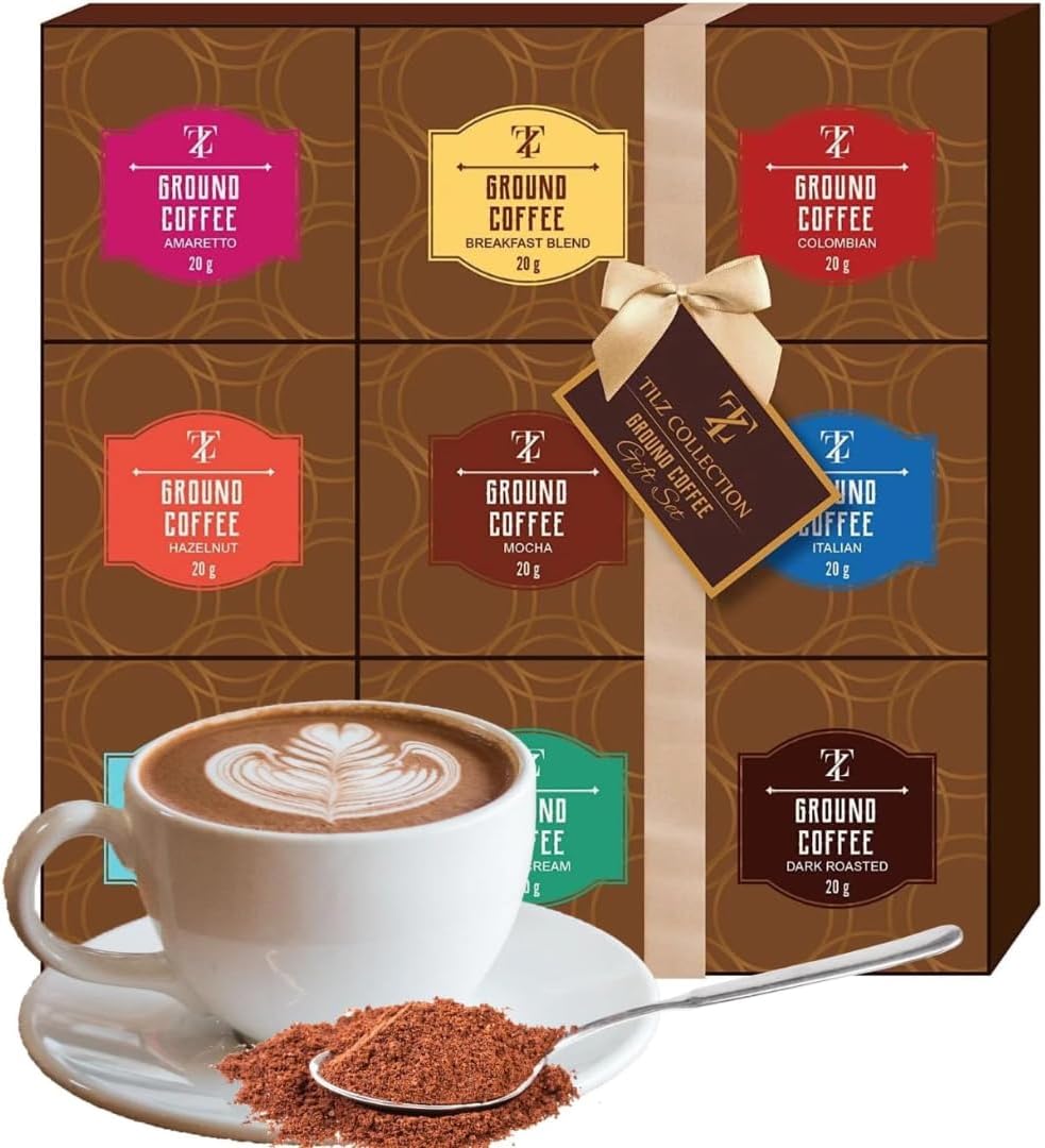 Ribboned gift box of nine ground coffee sachets beside a cup of latte