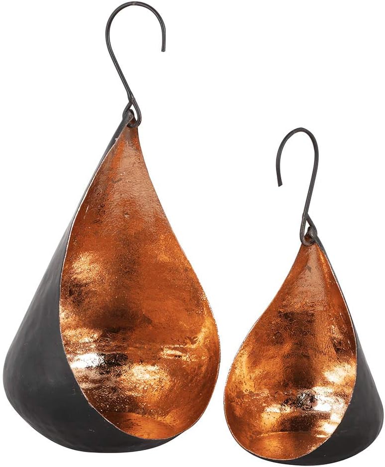 Two hanging teardrop-shaped tea light holders in hand-hammered matt black iron, open at the front to show a distressed copper interior, each on a curled metal hook