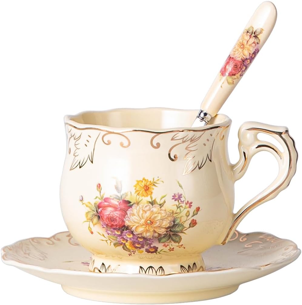 Cream vintage-style ceramic teacup and saucer painted with roses, with gold trim and a matching spoon