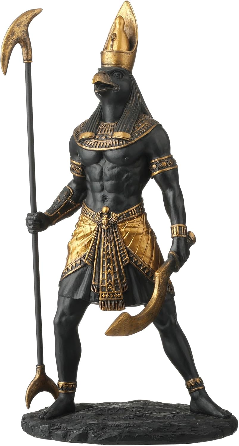 Black and gold figurine of the falcon-headed Egyptian god Horus in a tall gold crown and pleated gold kilt, holding a was sceptre and a curved khopesh blade, standing on a rocky base