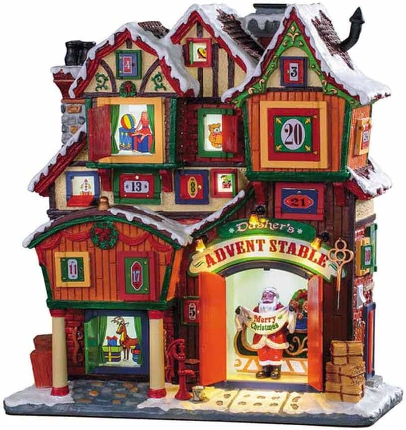 Lemax Dasher's Advent Stable village facade, a snowy timbered building covered in numbered doors and windows, some open to show toys and a reindeer, with Santa holding a Merry Christmas banner in the lit stable doorway
