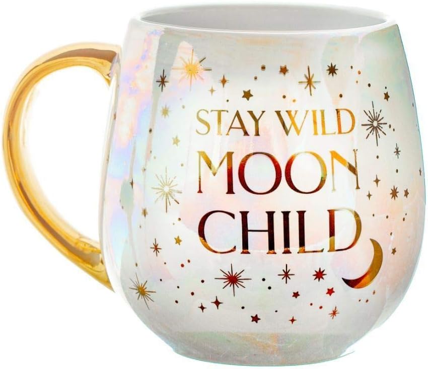 Pearlescent mug with a gold handle reading Stay Wild Moon Child in gold and red lettering among stars