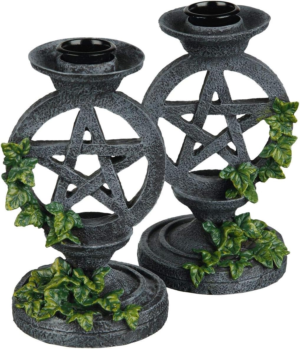 Pair of stone-effect resin candlesticks, each with an open pentagram ring wrapped in green ivy