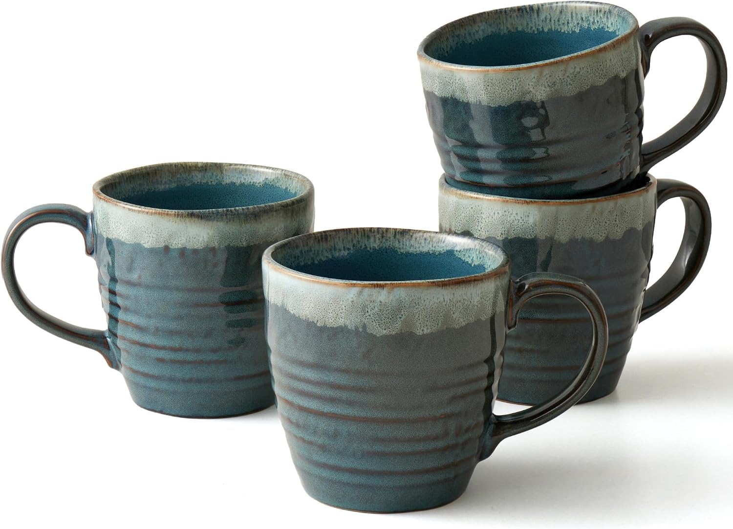 Four blue reactive-glaze stoneware mugs, each with a slightly different pattern