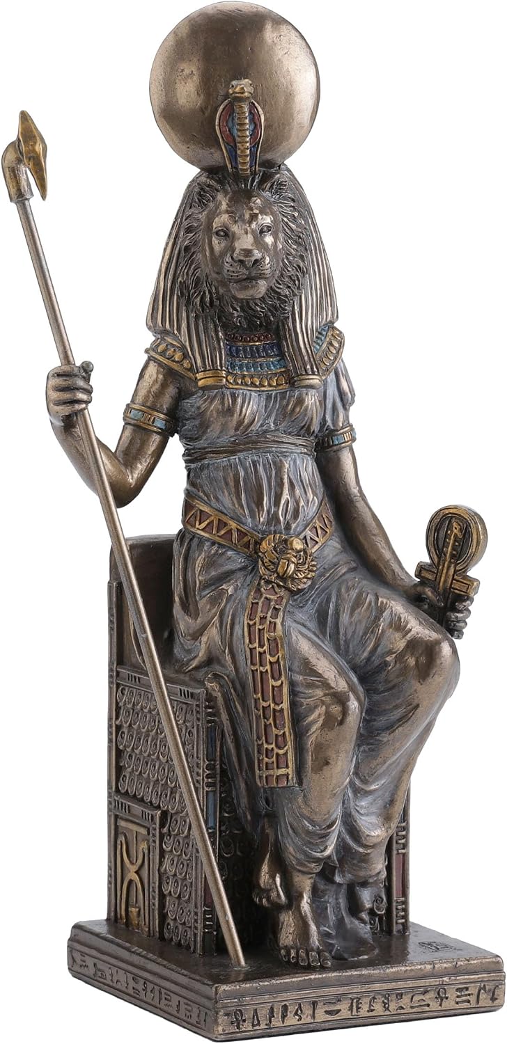 Cold-cast bronze figurine of the lion-headed Egyptian goddess Sekhmet seated on a throne, crowned with a sun disc and holding a staff