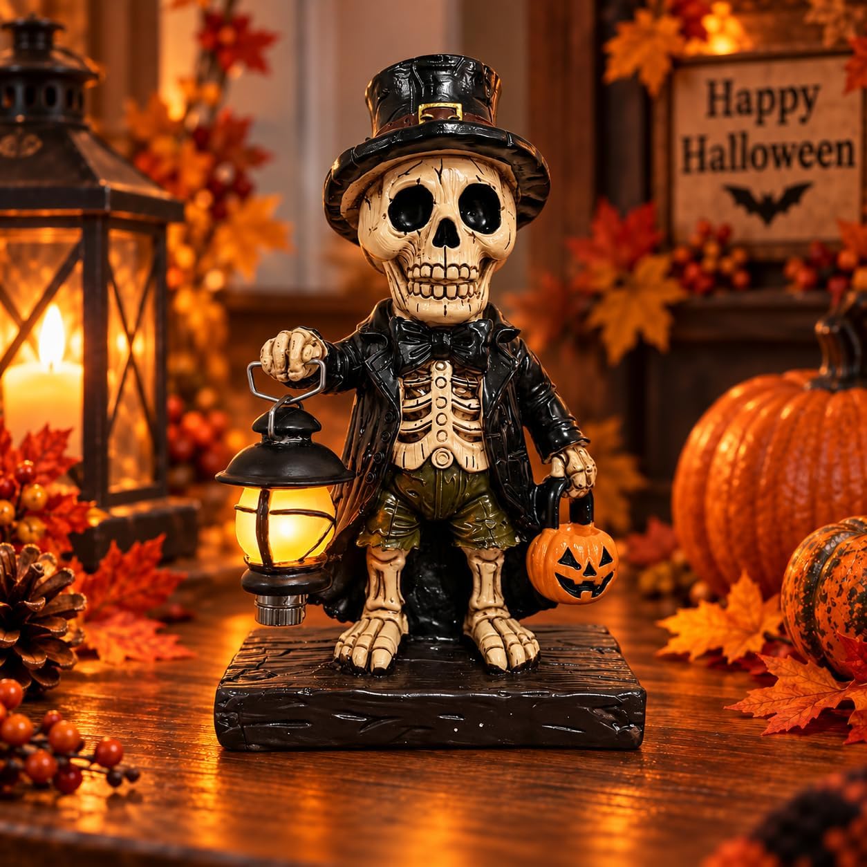 Resin skeleton figurine in a black top hat, frock coat and bow tie, holding a glowing lantern in one hand and a jack-o'-lantern bucket in the other, on a wooden-look base among autumn leaves and pumpkins