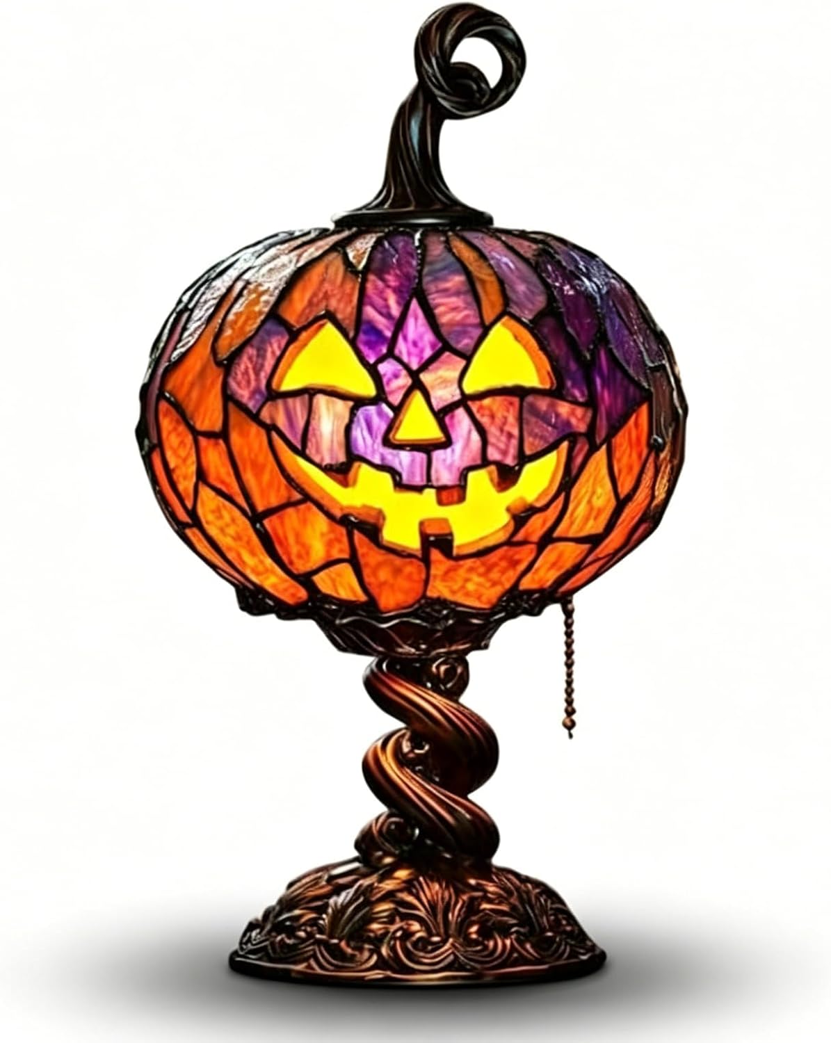 Stained-glass-style jack-o'-lantern table lamp in orange and purple glass with a glowing yellow face, a curled bronze stem on top, on a twisted bronze base with a pull chain