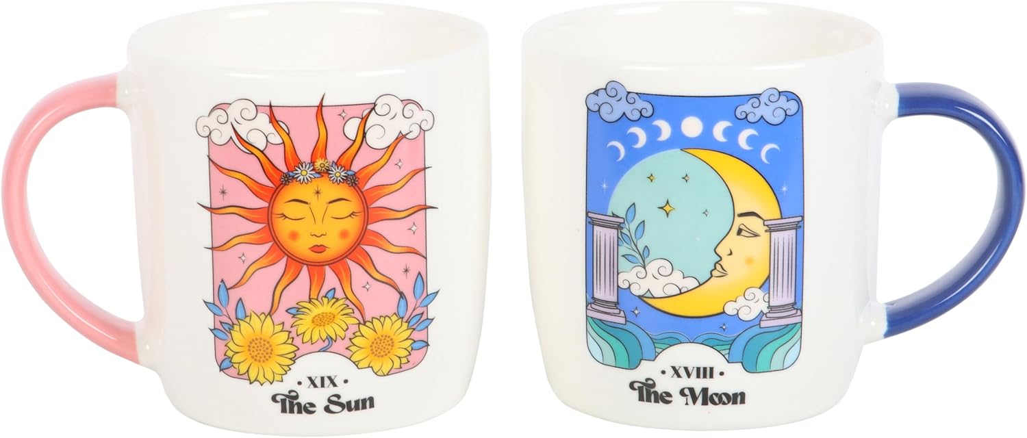 Pair of white mugs printed with The Sun and The Moon tarot cards, with pink and blue handles