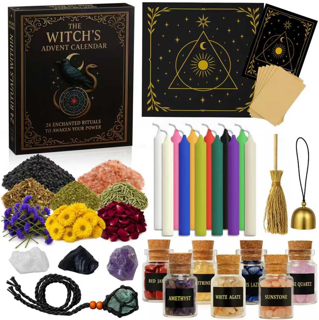 The Witch's Advent Calendar box with a raven and serpent on the cover, shown with its contents: a black and gold altar cloth, coloured spell candles, dried herbs and flowers, raw crystals, corked jars of gemstones, a mini broom, a brass bell and a crystal pendant