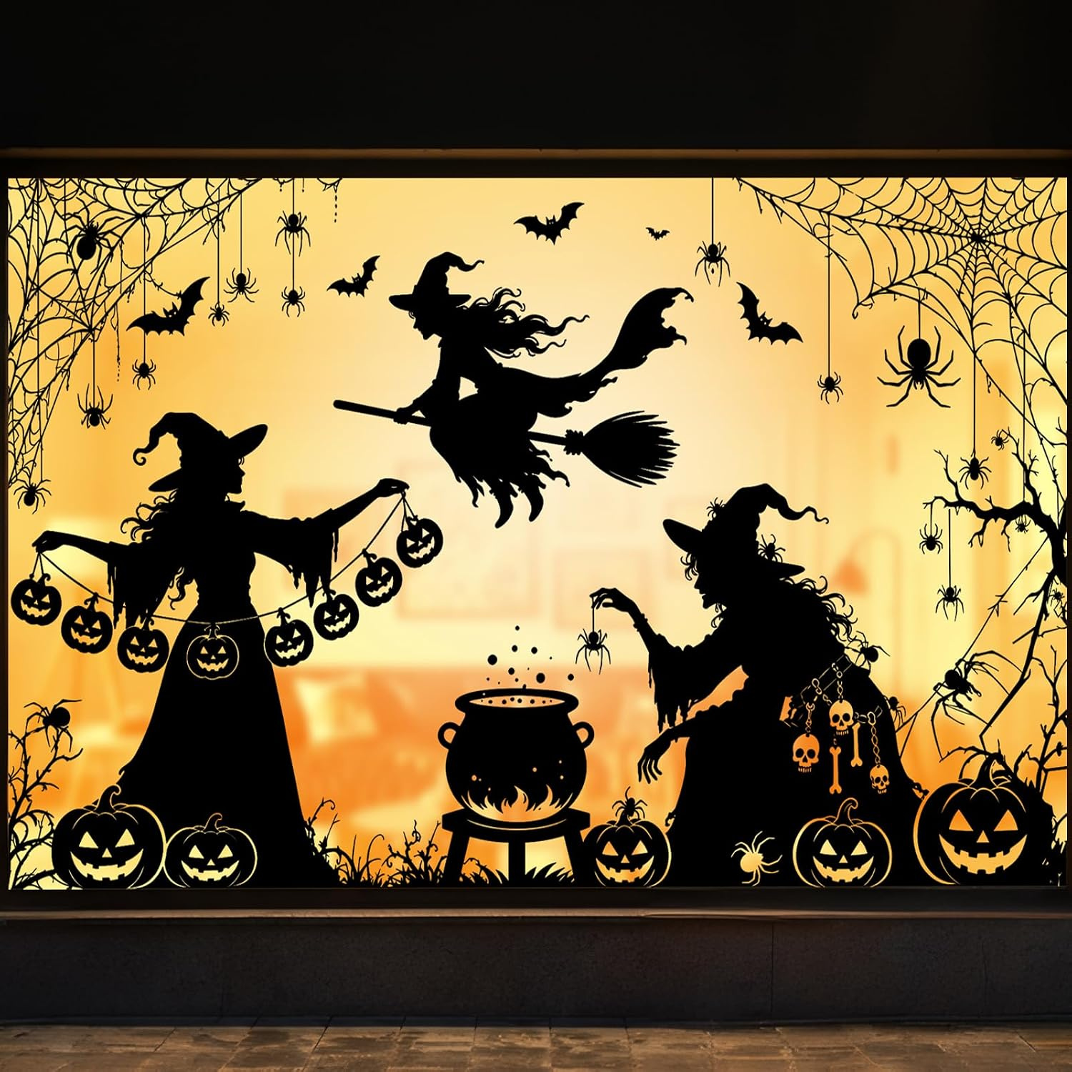 Reusable Halloween window cling decals of a broomstick witch, cauldron, pumpkins and cobwebs